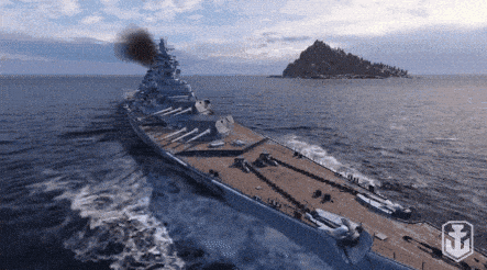 Battleship cutting through open ocean with smoke from the funnel and wake in the water